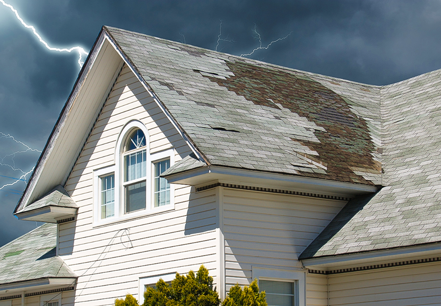 Storm damaged roof with missing shingles