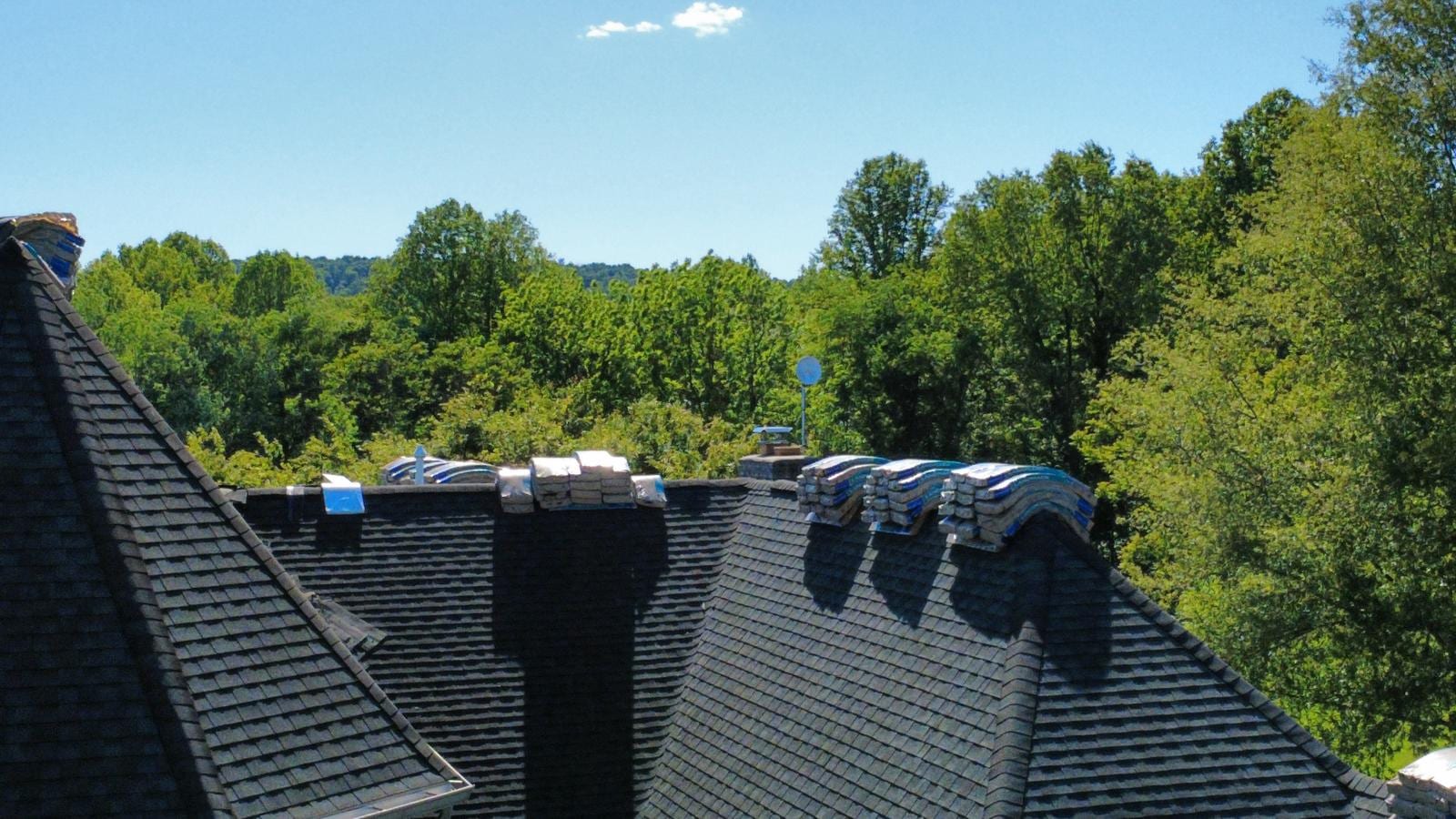 Fresh asphalt shingle roof with new shingle bundles staged on a Frederick County, MD home