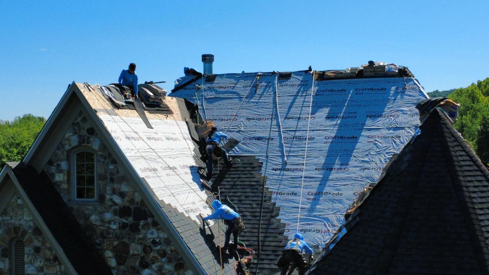 EZ Home Services crew installing a new asphalt shingle roof over CraftGrade underlayment on a Frederick, MD home